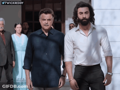 A Man With A Beard Stands Next To Another Man GIF