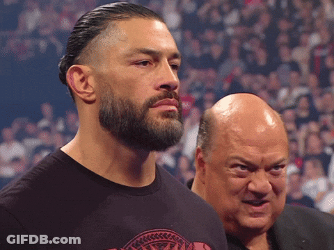 A Man With A Beard Stands Next To Another Man GIF