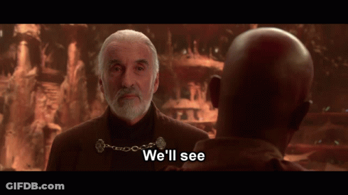 A Man With A Beard Talks To Another Man With The Words " We 'Ll See " Below Him GIF