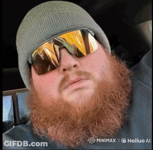 A Man With A Beard Wearing A Beanie And Sunglasses Has A Watermark That Says Hailuo Ai GIF