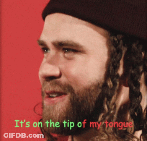 A Man With A Beard Wearing A Beanie Has The Words It 'S On The Tip Of My Tongue Above Him GIF