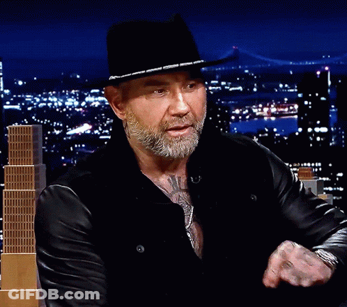 A Man With A Beard Wearing A Black Hat And A Leather Jacket GIF