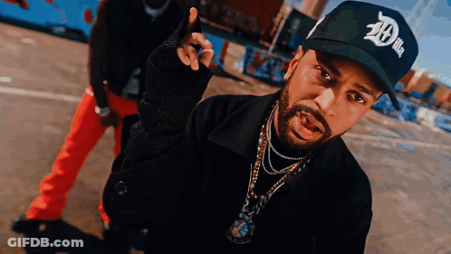 A Man With A Beard Wearing A Black Hat That Says 20 On It GIF