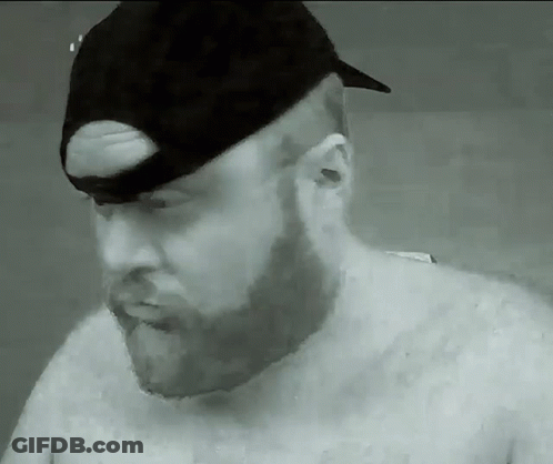 A Man With A Beard Wearing A Black Hat GIF
