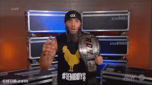 A Man With A Beard Wearing A Black Hat With 13X On It GIF