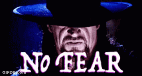 A Man With A Beard Wearing A Black Hat With The Words No Fear Written On It GIF