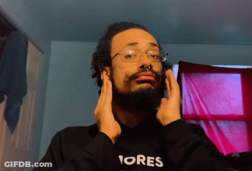 A Man With A Beard Wearing A Black Hoodie That Says Ores GIF