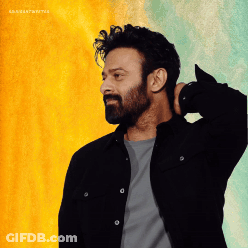 A Man With A Beard Wearing A Black Jacket And A Grey Shirt GIF