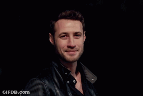 A Man With A Beard Wearing A Black Shirt And A Black Leather Jacket GIF