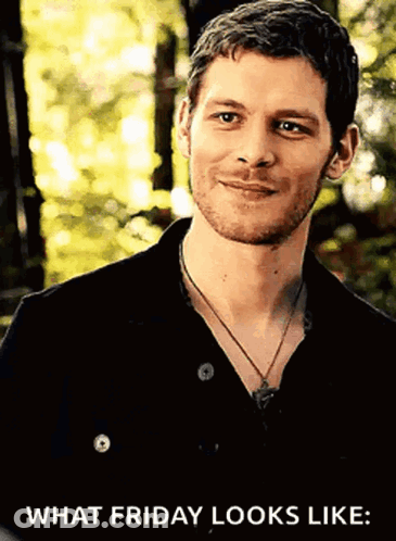 A Man With A Beard Wearing A Black Shirt And A Necklace Is Smiling And Says What Friday Looks Like GIF