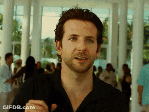 A Man With A Beard Wearing A Black Shirt Stands In Front Of A Crowd GIF