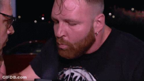 A Man With A Beard Wearing A Black Shirt That Says ' Aaron ' On It GIF