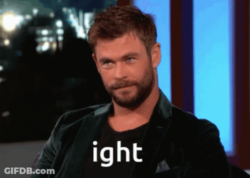 A Man With A Beard Wearing A Black Shirt That Says Ight GIF