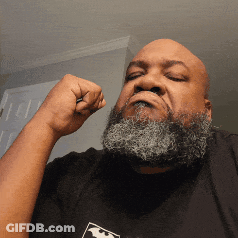 A Man With A Beard Wearing A Black Shirt With A Bat On It GIF