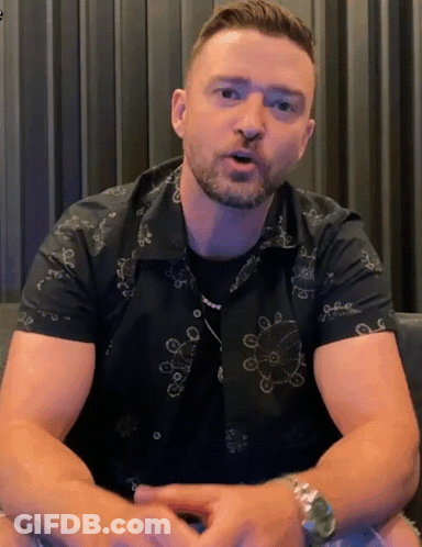 A Man With A Beard Wearing A Black Shirt With A Pattern Of Circles On It GIF