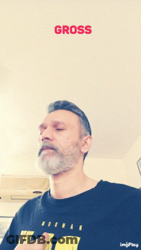 A Man With A Beard Wearing A Black Shirt With The Word Gross On It GIF