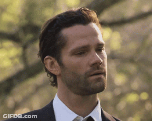 A Man With A Beard Wearing A Black Suit And White Shirt GIF
