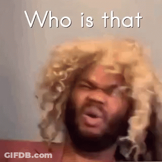 A Man With A Beard Wearing A Blonde Wig Is Making A Funny Face . GIF