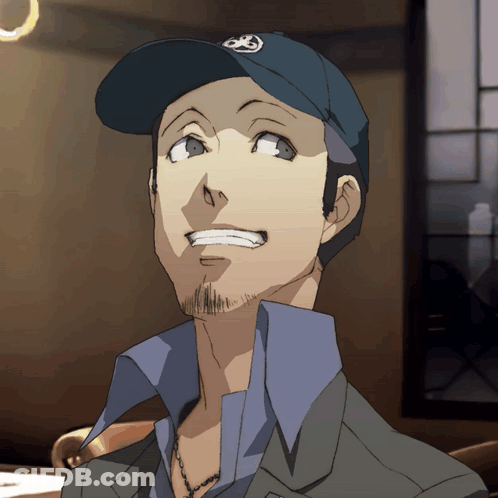 A Man With A Beard Wearing A Blue Hat With A Circle On It GIF