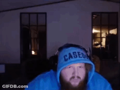 A Man With A Beard Wearing A Blue Hoodie That Says Caseon GIF