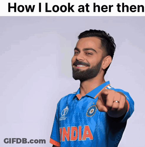 A Man With A Beard Wearing A Blue India Shirt Points At The Camera GIF