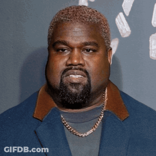 A Man With A Beard Wearing A Blue Jacket And A Gold Chain GIF