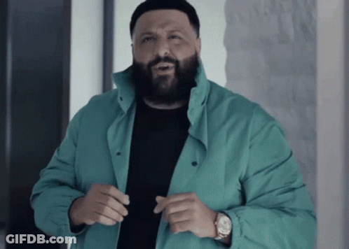 A Man With A Beard Wearing A Blue Jacket And A Watch GIF