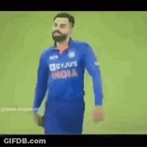 A Man With A Beard Wearing A Blue Jersey With The Word India On It . GIF