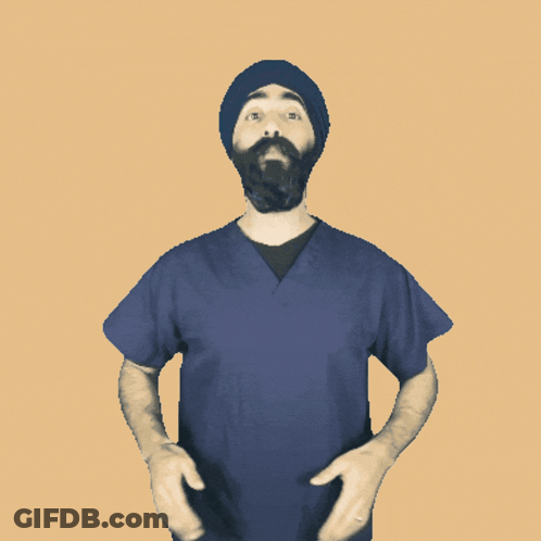 A Man With A Beard Wearing A Blue Scrub Top And A Black Hat GIF