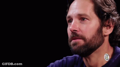 A Man With A Beard Wearing A Blue Shirt GIF
