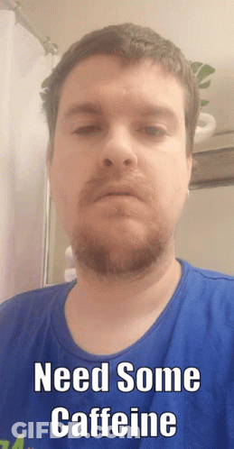 A Man With A Beard Wearing A Blue Shirt Says Need Some Caffeine GIF