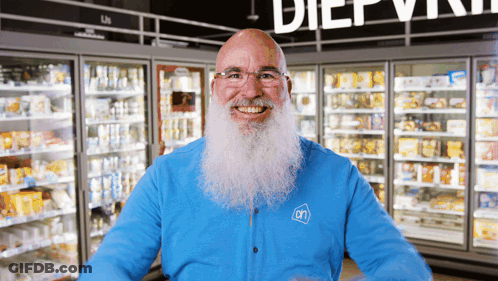 A Man With A Beard Wearing A Blue Shirt With An On Logo On It GIF