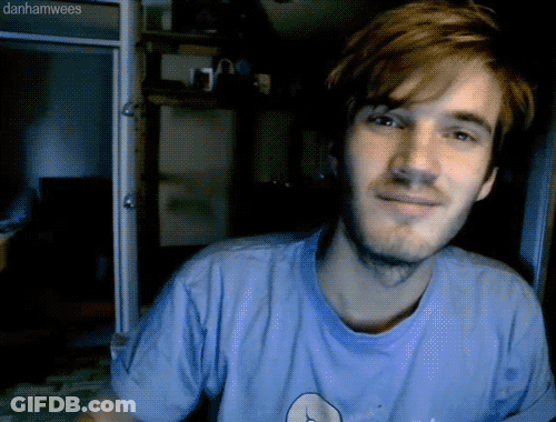 A Man With A Beard Wearing A Blue Shirt With Danhamwees Written On The Bottom GIF