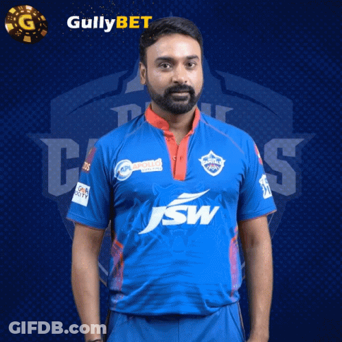 A Man With A Beard Wearing A Blue Shirt With Jsw On It GIF