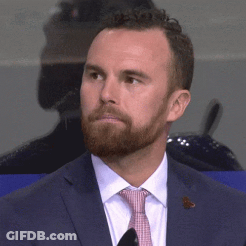 A Man With A Beard Wearing A Blue Suit And Tie GIF