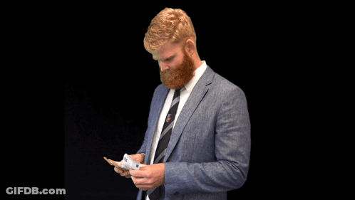 A Man With A Beard Wearing A Blue Suit And Tie GIF