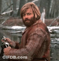 A Man With A Beard Wearing A Brown Jacket GIF