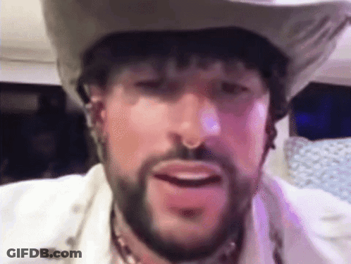 A Man With A Beard Wearing A Cowboy Hat . GIF