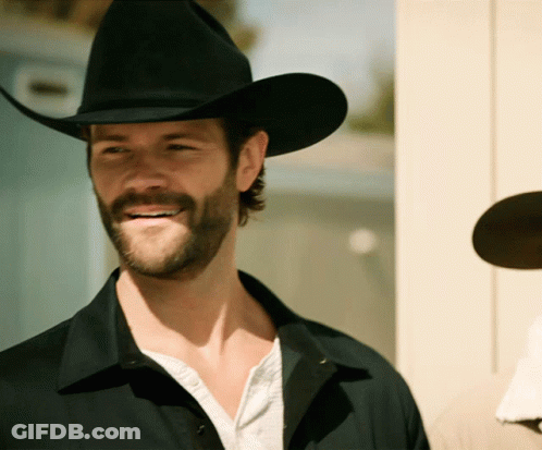A Man With A Beard Wearing A Cowboy Hat Smiles GIF