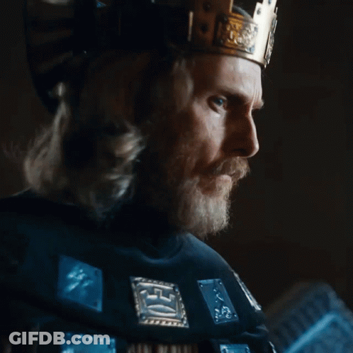 A Man With A Beard Wearing A Crown And A Black Shirt With The Word King On It GIF