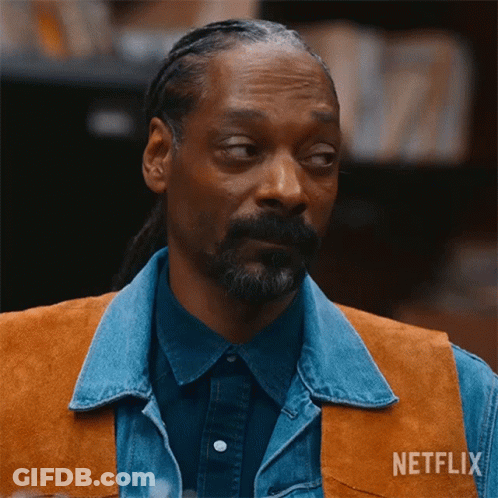 A Man With A Beard Wearing A Denim Vest And A Netflix Logo On His Chest GIF