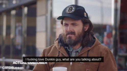 A Man With A Beard Wearing A Dunkin Donuts Hat Talks To Another Man GIF