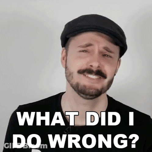A Man With A Beard Wearing A Flat Cap And A Black Shirt Says What Did I Do Wrong GIF