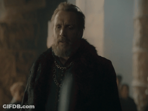 A Man With A Beard Wearing A Fur Coat And A Necklace GIF