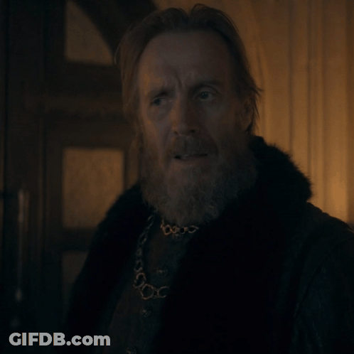 A Man With A Beard Wearing A Fur Coat And A Necklace GIF