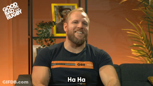 A Man With A Beard Wearing A Gbr Shirt Says Ha Ha GIF