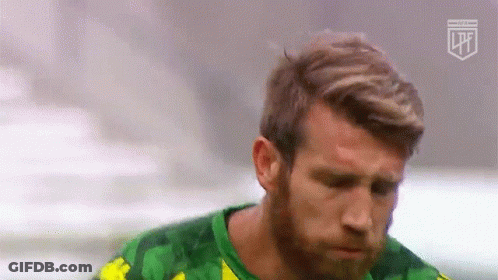 A Man With A Beard Wearing A Green And Yellow Shirt GIF