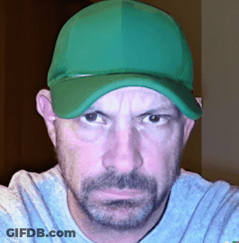 A Man With A Beard Wearing A Green Hat And A Blue Shirt GIF