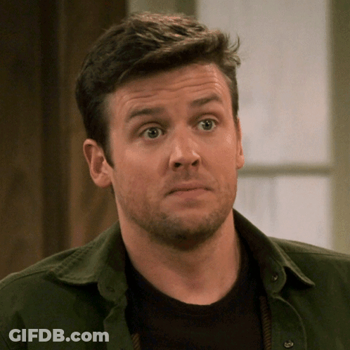 A Man With A Beard Wearing A Green Shirt And A Black Shirt GIF