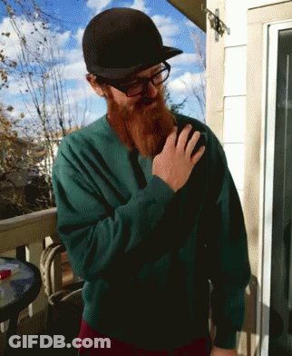 A Man With A Beard Wearing A Green Sweater And A Black Hat GIF